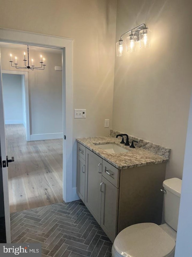 937 Swinehart Rd Unit C, Boyertown, PA 19512 - bathroom with a chandelier, vanity, and wood finished floors