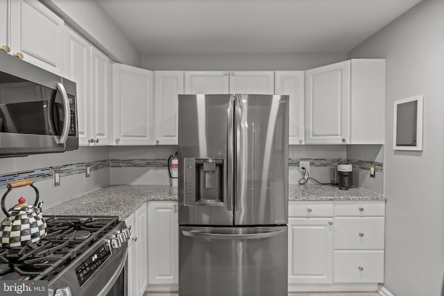 703 Wharton Rd, Mount Laurel, NJ 08054 - kitchen featuring stainless steel appliances, backsplash, white cabinets, and light stone counters