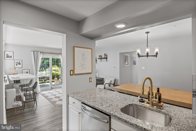 703 Wharton Rd, Mount Laurel, NJ 08054 - kitchen featuring dishwasher, light stone counters, white cabinets, pendant lighting, and a chandelier