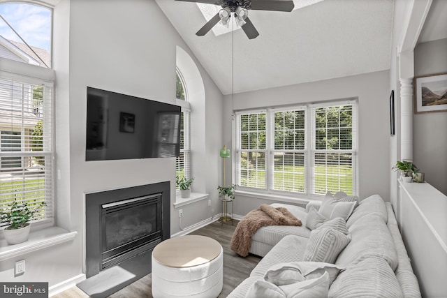 703 Wharton Rd, Mount Laurel, NJ 08054 - living area with wood finished floors, a glass covered fireplace, ceiling fan, healthy amount of natural light, and high vaulted ceiling