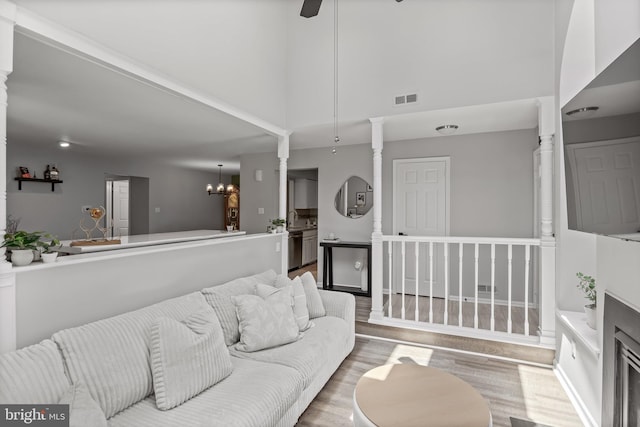 703 Wharton Rd, Mount Laurel, NJ 08054 - living area featuring wood finished floors, a chandelier, decorative columns, and ceiling fan
