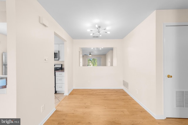 2802B Yarmouth Ln, Mount Laurel, NJ 08054 - unfurnished dining area featuring a chandelier, light wood finished floors, and ceiling fan