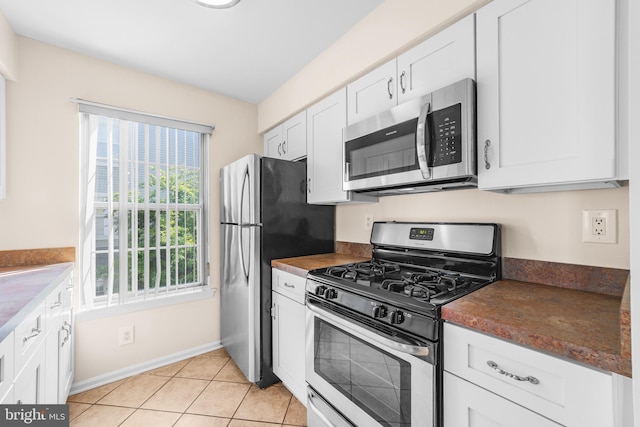 2802B Yarmouth Ln, Mount Laurel, NJ 08054 - kitchen featuring appliances with stainless steel finishes, dark countertops, white cabinets, and light tile patterned flooring