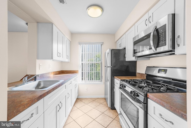 2802B Yarmouth Ln, Mount Laurel, NJ 08054 - kitchen featuring stainless steel appliances, white cabinetry, light tile patterned flooring, and dark countertops