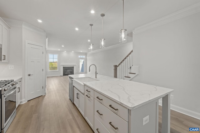 103 Laconia Ln, Charlottesville, VA 22911 - kitchen featuring appliances with stainless steel finishes, open floor plan, white cabinetry, a center island with sink, and crown molding