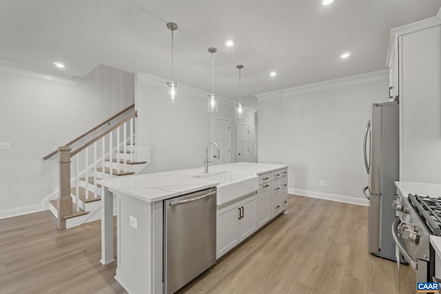 103 Laconia Ln, Charlottesville, VA 22911 - kitchen with stainless steel appliances, crown molding, an island with sink, white cabinets, and light wood-style flooring