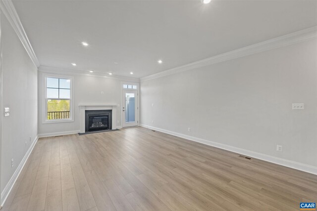103 Laconia Ln, Charlottesville, VA 22911 - unfurnished living room with ornamental molding, light wood finished floors, a glass covered fireplace, and recessed lighting