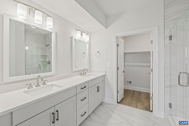 103 Laconia Ln, Charlottesville, VA 22911 - full bathroom featuring double vanity, a shower stall, a walk in closet, and marble look tiles