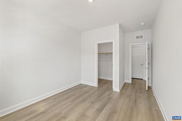 103 Laconia Ln, Charlottesville, VA 22911 - unfurnished bedroom with light wood finished floors, a closet, and a spacious closet