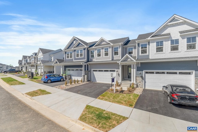 103 Laconia Ln, Charlottesville, VA 22911 - townhome / multi-family property featuring a residential view, driveway, a garage, and stone siding
