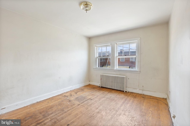11 Rosedale St, Baltimore, MD 21229 - spare room featuring radiator and wood finished floors