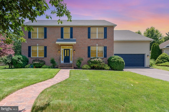 3 Baird Ct, Carlisle, PA 17013 - colonial home featuring driveway, a garage, a front lawn, brick siding, and roof with shingles