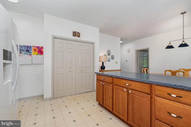 3 Baird Ct, Carlisle, PA 17013 - kitchen featuring light flooring, dark countertops, white fridge with ice dispenser, and brown cabinetry