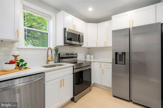 4618 Arabia Ave, Baltimore, MD 21214 - kitchen featuring stainless steel appliances, light countertops, white cabinets, tasteful backsplash, and recessed lighting