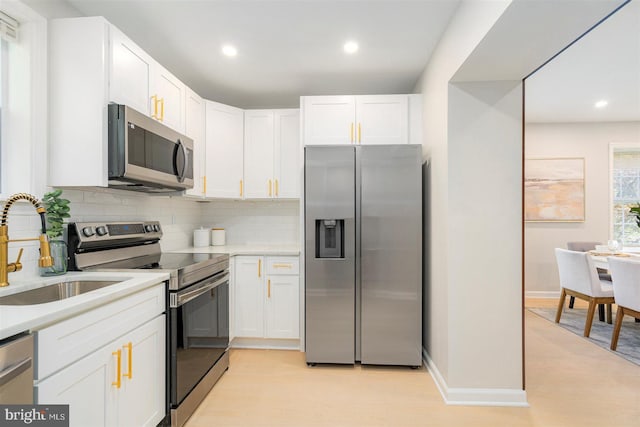 4618 Arabia Ave, Baltimore, MD 21214 - kitchen featuring stainless steel appliances, backsplash, recessed lighting, white cabinetry, and light countertops