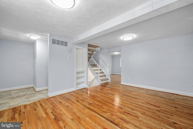 1632 Barnstead Dr, Reston, VA 20194 - finished basement featuring wood finished floors, stairs, and a textured ceiling