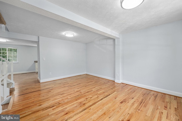1632 Barnstead Dr, Reston, VA 20194 - below grade area featuring a textured ceiling, wood finished floors, and stairway
