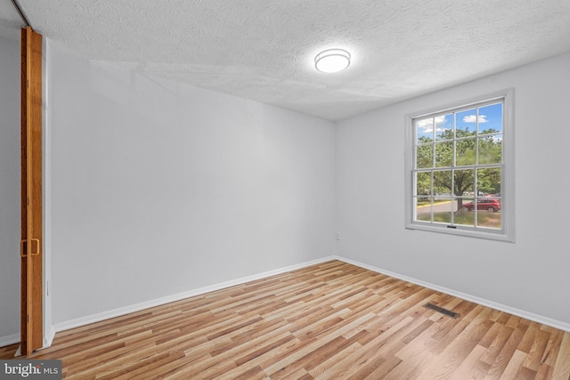 1632 Barnstead Dr, Reston, VA 20194 - spare room with light wood finished floors and a textured ceiling