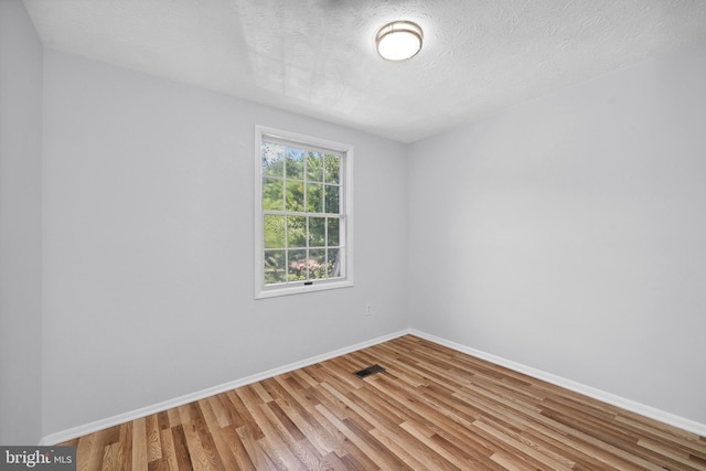 1632 Barnstead Dr, Reston, VA 20194 - spare room with wood finished floors and a textured ceiling