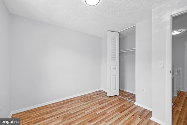 1632 Barnstead Dr, Reston, VA 20194 - unfurnished bedroom with wood finished floors, a closet, and a textured ceiling