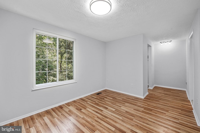 1632 Barnstead Dr, Reston, VA 20194 - spare room with a textured ceiling and light wood-style flooring