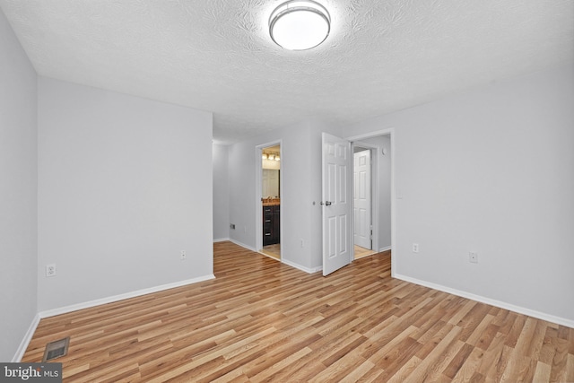 1632 Barnstead Dr, Reston, VA 20194 - spare room with light wood-type flooring and a textured ceiling