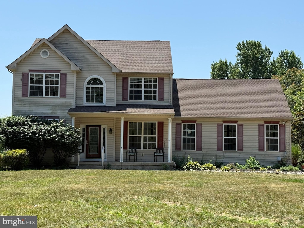 1686 Catawba Ave, Newfield, NJ 08344 - traditional home with covered porch, a front yard, and a shingled roof