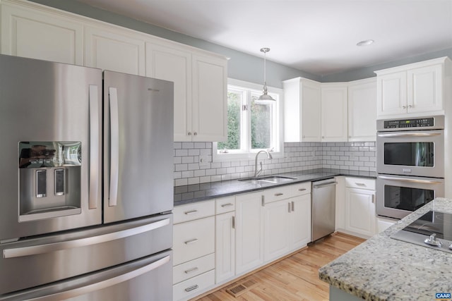 325 Heron Ln, Charlottesville, VA 22903 - kitchen featuring stainless steel appliances, white cabinets, light wood finished floors, hanging light fixtures, and recessed lighting