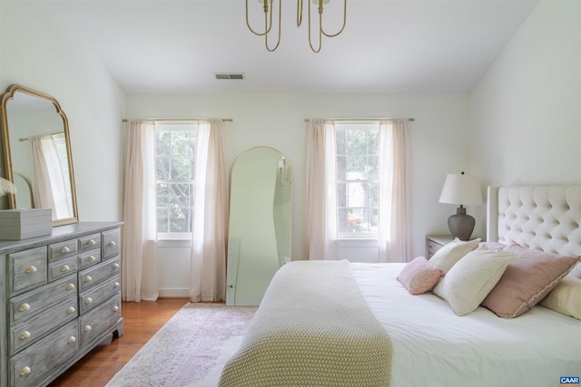 325 Heron Ln, Charlottesville, VA 22903 - bedroom featuring wood finished floors and a chandelier