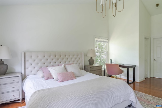 325 Heron Ln, Charlottesville, VA 22903 - bedroom featuring wood finished floors, a chandelier, and a high ceiling