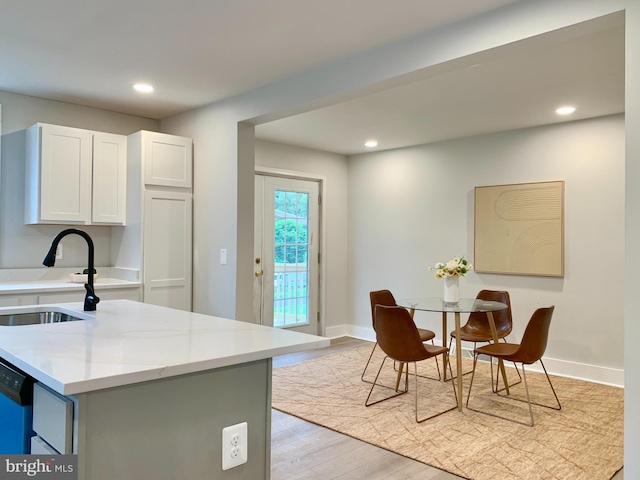 840 Columbia Ave, Cumberland, MD 21502 - kitchen featuring white cabinetry, recessed lighting, light wood-style floors, dishwasher, and a center island with sink