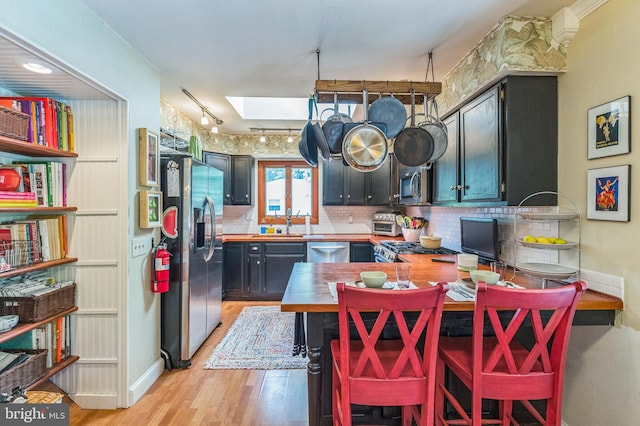 238 Winding Way Rd, Stratford, NJ 08084 - kitchen featuring stainless steel appliances, a skylight, tasteful backsplash, and light wood finished floors