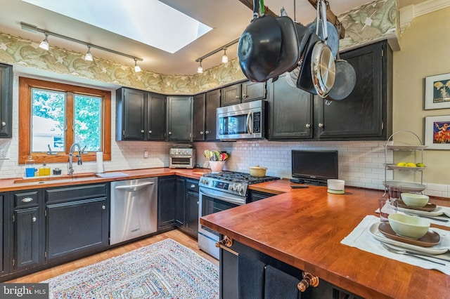 238 Winding Way Rd, Stratford, NJ 08084 - kitchen featuring appliances with stainless steel finishes, butcher block counters, rail lighting, a skylight, and light wood-type flooring