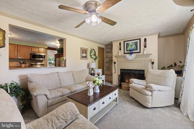 381 Youngs Dr, Front Royal, VA 22630 - living room featuring a textured ceiling, ceiling fan, ornamental molding, a lit fireplace, and light carpet