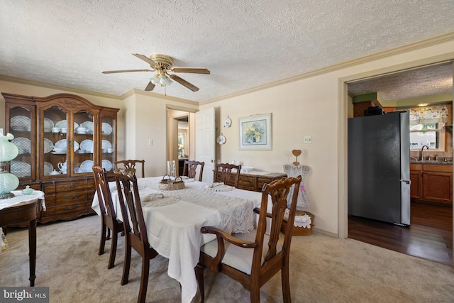 381 Youngs Dr, Front Royal, VA 22630 - dining space with light colored carpet, crown molding, a ceiling fan, and a textured ceiling