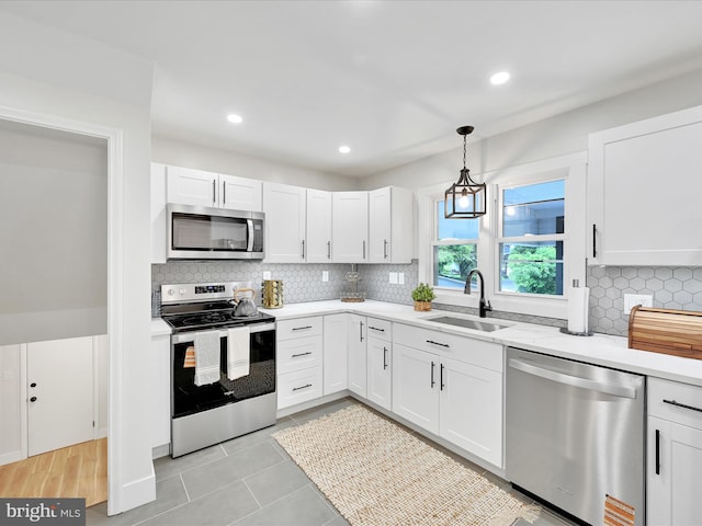 1020 Wyomissing Blvd, Wyomissing, PA 19610 - kitchen featuring appliances with stainless steel finishes, light countertops, white cabinetry, backsplash, and recessed lighting