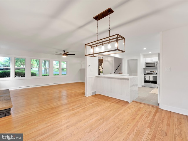 1020 Wyomissing Blvd, Wyomissing, PA 19610 - unfurnished living room featuring a baseboard heating unit, a ceiling fan, light wood finished floors, and recessed lighting