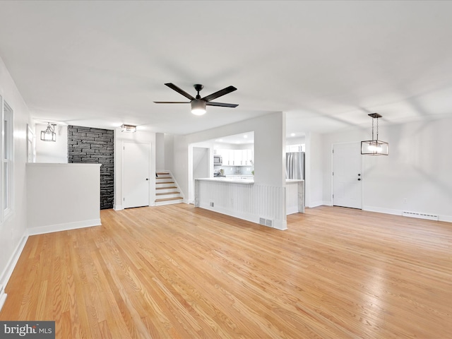 1020 Wyomissing Blvd, Wyomissing, PA 19610 - unfurnished living room with ceiling fan, light wood-style floors, and stairway