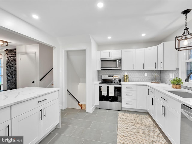 1020 Wyomissing Blvd, Wyomissing, PA 19610 - kitchen with stainless steel appliances, tasteful backsplash, light tile patterned flooring, white cabinetry, and recessed lighting