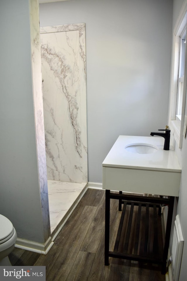 607 N Broom St, Wilmington, DE 19805 - full bath with a marble finish shower, wood finished floors, and vanity