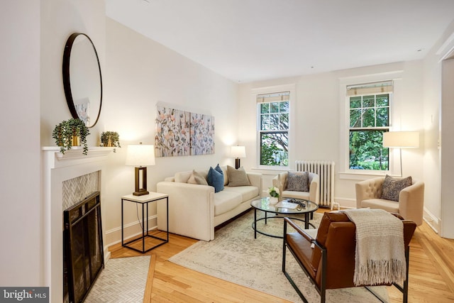 3105 17th St NW, Washington, DC 20010 - living area with radiator, wood finished floors, and a tiled fireplace