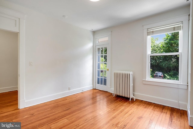 3105 17th St NW, Washington, DC 20010 - spare room featuring radiator and light wood-style flooring