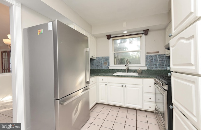 15 Constance Dr, Hamilton, NJ 08620 - kitchen featuring appliances with stainless steel finishes, light tile patterned flooring, dark countertops, and backsplash
