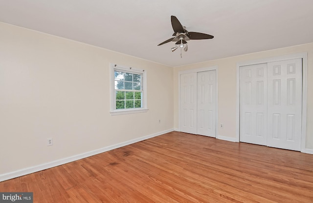 15 Constance Dr, Hamilton, NJ 08620 - unfurnished bedroom featuring multiple closets, light wood-style floors, and a ceiling fan