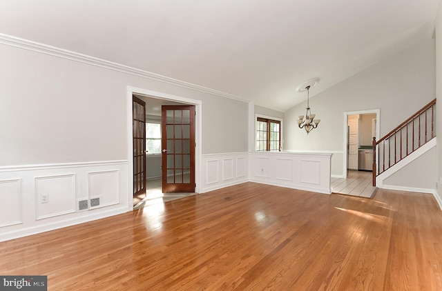 15 Constance Dr, Hamilton, NJ 08620 - unfurnished room featuring a chandelier, light wood-style floors, french doors, stairs, and wainscoting