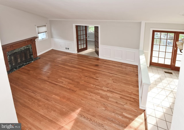 15 Constance Dr, Hamilton, NJ 08620 - unfurnished living room featuring wood finished floors, plenty of natural light, wainscoting, ornamental molding, and a decorative wall