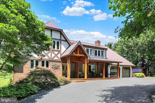 615 Beinhower Rd, Etters, PA 17319 - english style home featuring covered porch, a garage, a shed, brick siding, and a metal roof