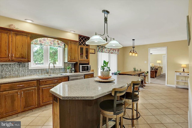 615 Beinhower Rd, Etters, PA 17319 - kitchen featuring stainless steel appliances, light tile patterned flooring, a kitchen bar, a center island, and tasteful backsplash
