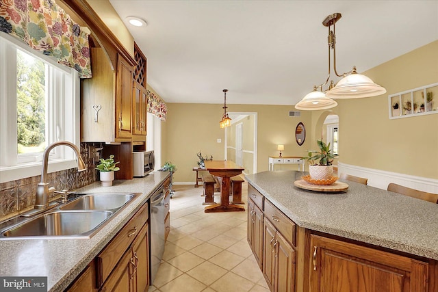 615 Beinhower Rd, Etters, PA 17319 - kitchen with stainless steel appliances, brown cabinets, light tile patterned flooring, and hanging light fixtures