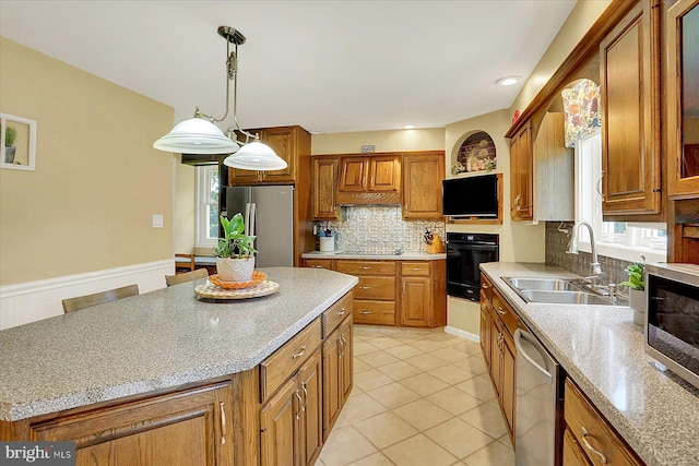 615 Beinhower Rd, Etters, PA 17319 - kitchen with black appliances, brown cabinets, light tile patterned floors, tasteful backsplash, and a center island